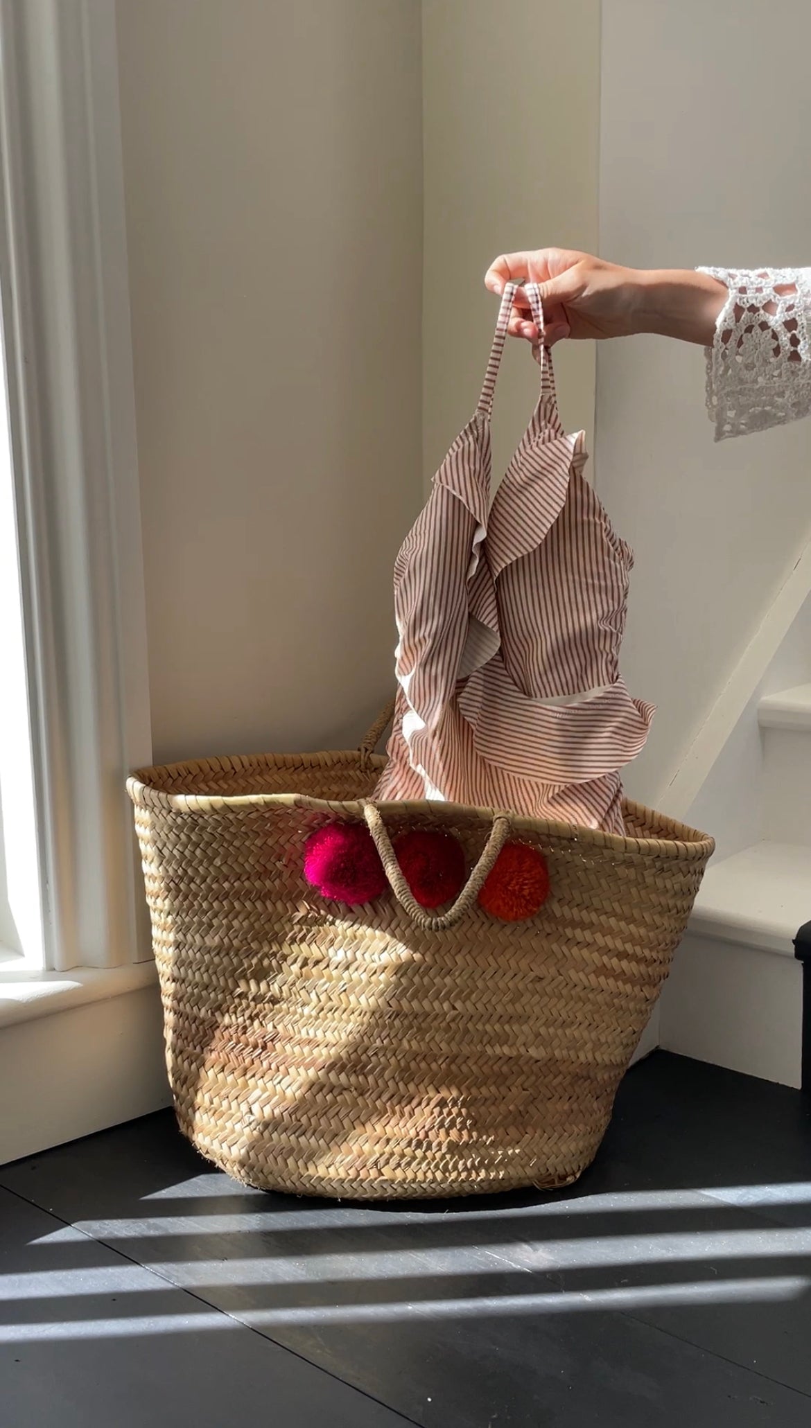 Summer swimming costume being washed and put into woven basket